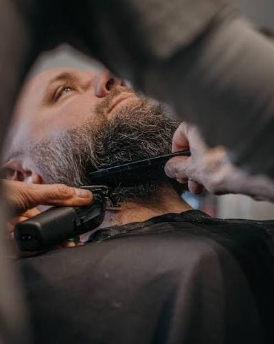 Professional beard trim with clipper and comb